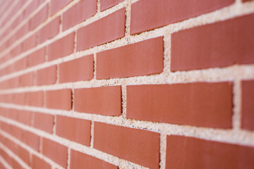 Background in the form of a red brick wall. Copy space.