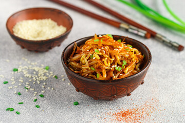 Spicy mung bean sprouts salad with garlic, sesame seeds, green onions, soy sauce, spices and red pepper. Kongnamul Muchim. Traditional Korean dish. selective focus