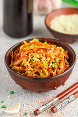 Spicy mung bean sprouts salad with garlic, sesame seeds, green onions, soy sauce, spices and red pepper. Kongnamul Muchim. Traditional Korean dish. selective focus
