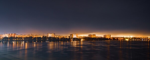 Big Dnieper river in the huge night bright city of Dnipropetrovsk in Ukraine