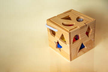 Obraz premium Cute wooden handmade toys for kids on yellow background. Ecological toys concept
