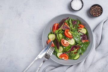 Healthy fresh salad of vegetable cucumber, tomato, spinach, arugula