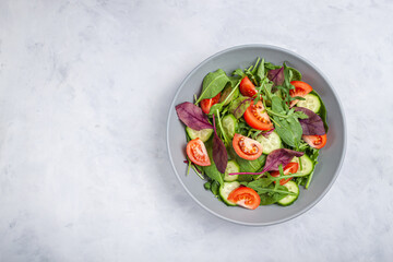Healthy fresh salad of vegetable cucumber, tomato, spinach, arugula