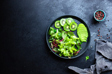 kiwi avocado green fresh salad mix leaves ready to eat on the table meal snack outdoor top view copy space for text food background rustic 