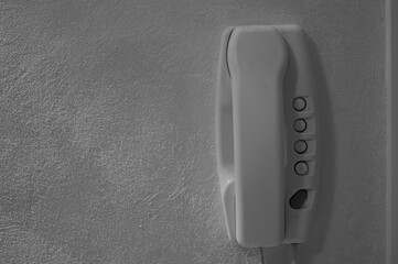 The cornet of an intercom hanging on the wall (Pesaro, Italy, Europe)