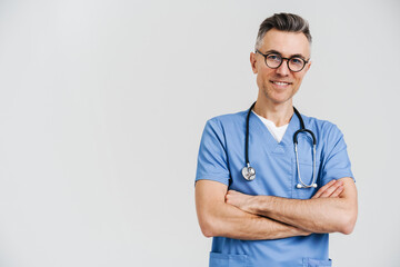 Happy white-haired medical doctor with stethoscope smiling at camera
