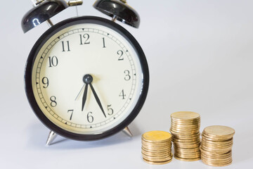 Saving money as a concept. Vintage retro stack of gold coins on the wooden background to represent It's time to do investing for retirement planning.