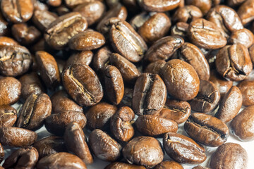 Coffee beans isolated on white background. Close up of a bean of coffee to represent the good smell.	