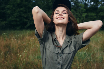 Woman outdoors Smiling fresh air looks upward closed eyes green leaves 