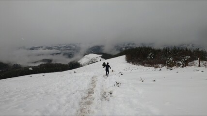 young man running in a snowed mountain