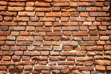Fragment of a wall of the old building with handwork bricks. Original background.