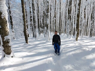 young man running in a snowed mountain