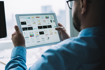 Man using tablet with diagrams and graphics