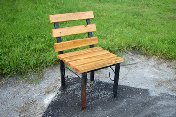 A small decorative chair in a city park.