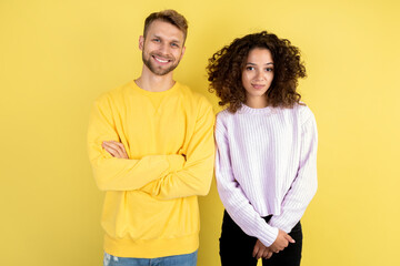 Obraz premium Mixed race friends standing on yellow background