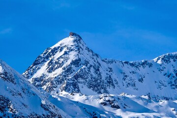 Scenic View Of Snow Covered Mountains Against Blue Sky