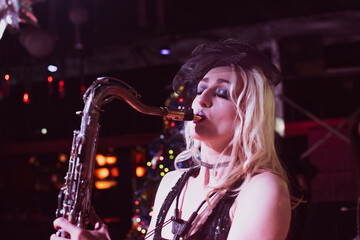 Beautiful young female saxophonist - 405219308