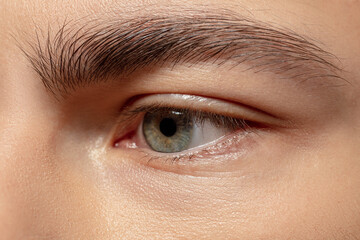 Obraz premium Eye sad. Close up face of young man on white studio background. Caucasian attractive male model. Concept of fashion and beauty, self-care, body and skin care. Handsome boy with well-kept skin.