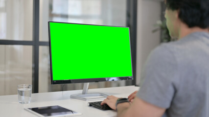Fototapeta premium Businessman Using Desktop with Green Chroma Key Screen