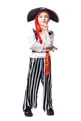 Portrait of a smiling boy in a pirate costume and hat posing, pretending to be pensive and looking slyly on white isolated background. Children's costume for the holidays