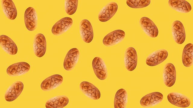 seamless looping animation of a whole diet loafs that wiggle top view. pattern of a bread above a yellow background, copy space