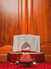 Fototapeta na wymiar bible placed on top of a guitar in an enclosed space, leaning against a wooden wall