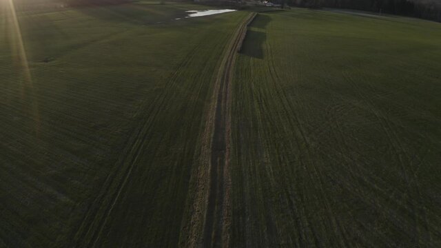 An aerial view of a road in a beautiful greenfield