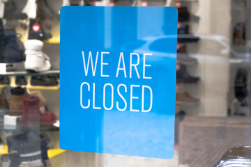 WE ARE CLOSED sign on the front door of shop due to the coronavirus COVID19 pandemic.