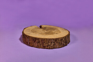 Round wooden saw cut cylinder shape on color abstract background. Minimal box and geometric podium. Scene with geometrical forms. Empty showcase for eco cosmetic product presentation