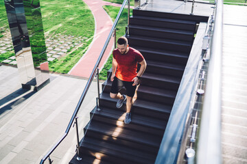 Sporty athlete running downstairs in city