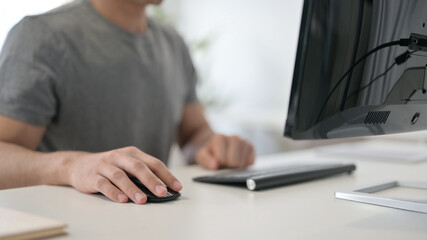 Hands of Young Man Using Mouse and Keyboard, Close Up 