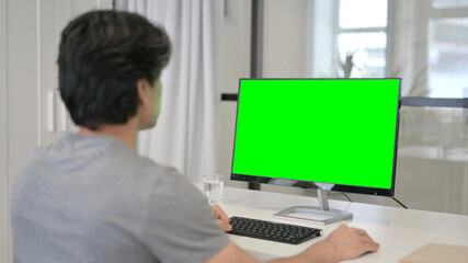 Fototapeta na wymiar Businessman Using Desktop with Green Chroma Key Screen 