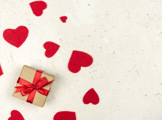 Red hearts with a gift on a white background.Valentine's Day, background with space for text.