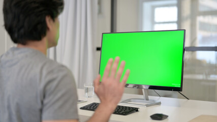 Fototapeta na wymiar Video Call by Businessman on Desktop with Green Chroma Key Screen, 