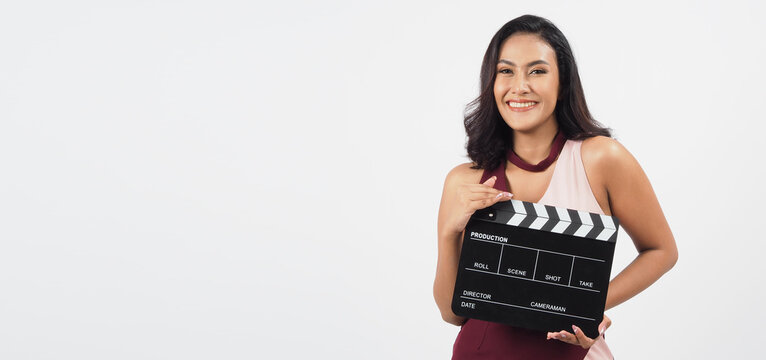 Asian sexy woman hold black clapper board or clapperboard or movie slate isolated on white background.She have tan skin ,show film,movies or cinema production concept.  cinema production concept.