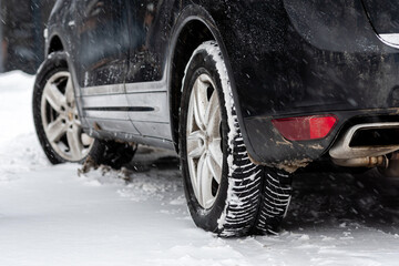 close-up of car wheels rubber tire in deep snow, transportation and safety concept