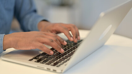 African Man Typing on Laptop Keyboard, Close Up 