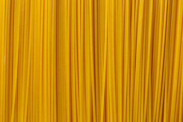 Yellow long spaghetti background close-up. Macro photography.