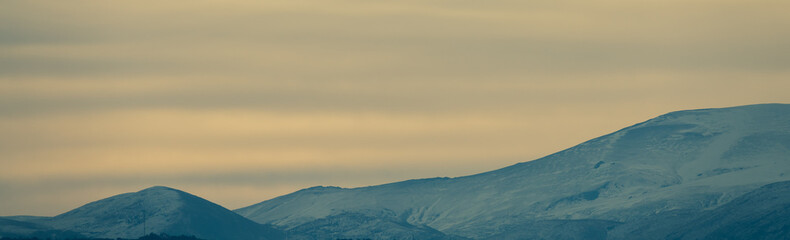 View of the highest peaks of Sierra Nevada (Granada, Spain) on a cloudy winter morning at sunrise