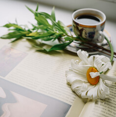 magazine with photos, Cup of coffee and flowers