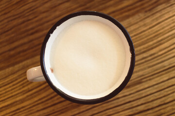 Close up of a cup of coffee on the table in the cafe.