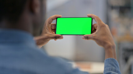 African Man Watching Video on Smartphone with Chroma Screen