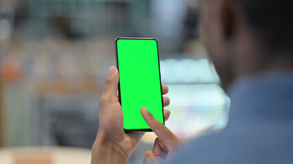 African Man Using Smartphone with Green Chroma Key Screen