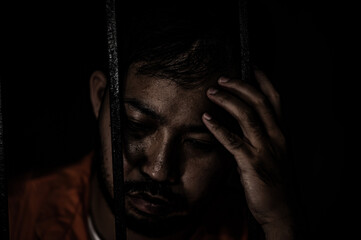 Asian man desperate at the iron prison,prisoner concept,thailand people,Hope to be free,Serious...