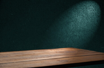 image of a wooden table on an abstract dark background with light in the center