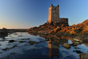 Seymour tower, Jersey, U.K. 19th century military building built on a rocky reef 1 mile from the coast which becomes surrounded by the sea with a 9-10 metre high tide. © alagz