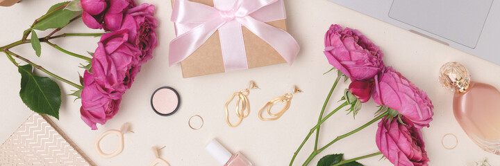 Banner with scattered gift, laptop, flowers, feminine cosmetics and accessories on a beige...