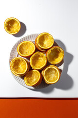 Orange peels on colorful background after being squeezed