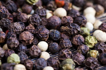 black peas pepper on an old wooden table