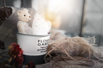 Cute valentine's bear with white heart in aluminium bucket .Valentine day concept background.